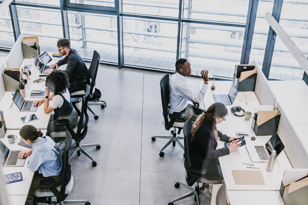 A busy office with people working .